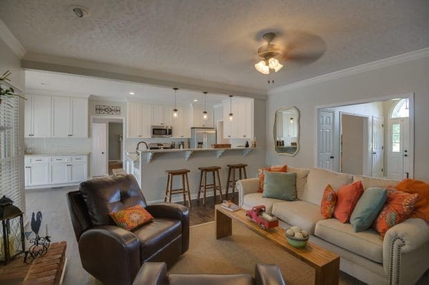 living room with modern white kitchen and foyer 